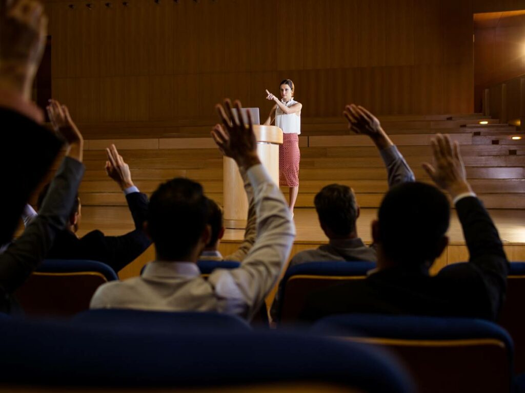 Female business executive giving a speech at conference center