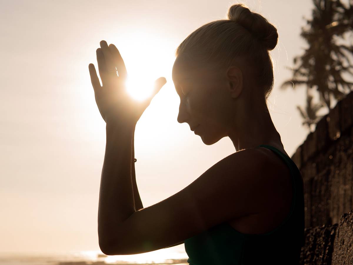 beautiful woman meditating outdoors. bali