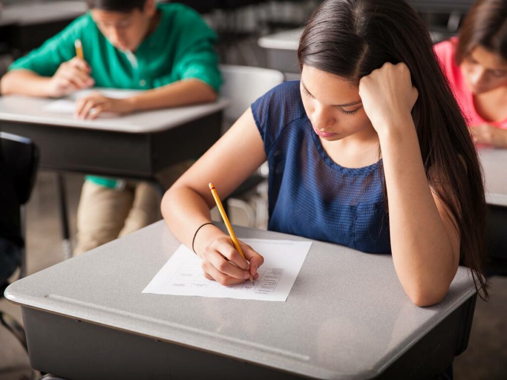 Group of high school students taking a test in a classroom