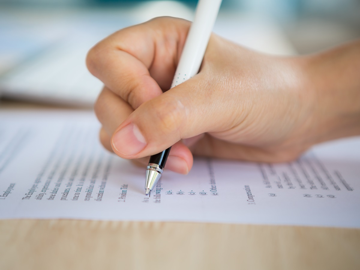 Close up of hand completing an employment application form