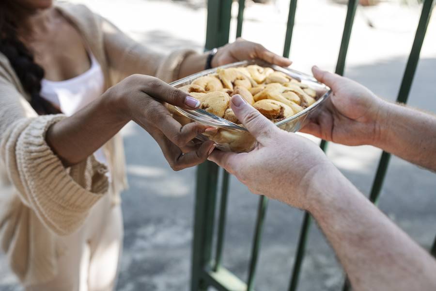 woman-offering-food-neighbor