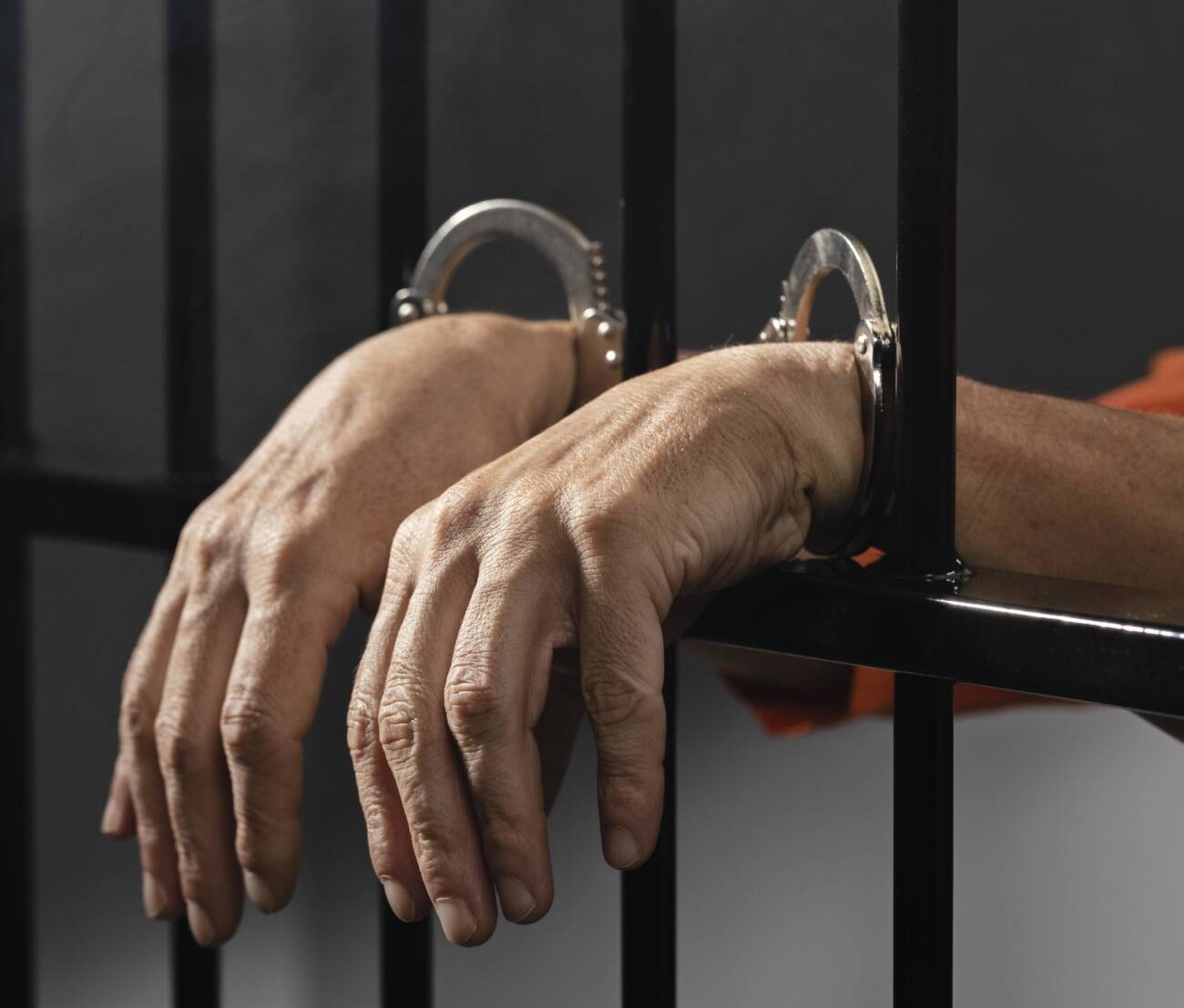 close-up-hand-wearing-cuffs-jail