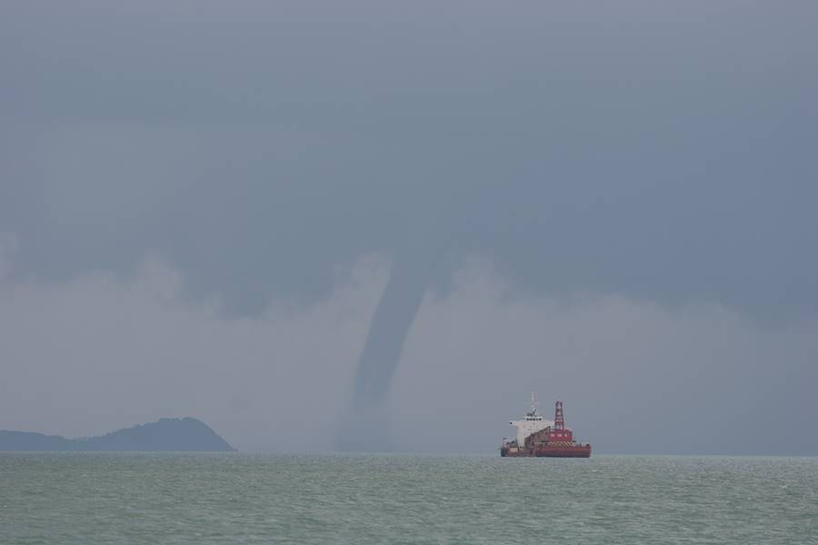 boat-sailing-sea-against-storm-clouds