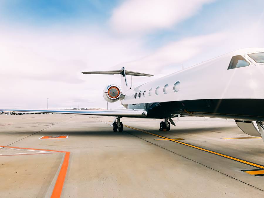 Private luxury jet at the airport terminal runway