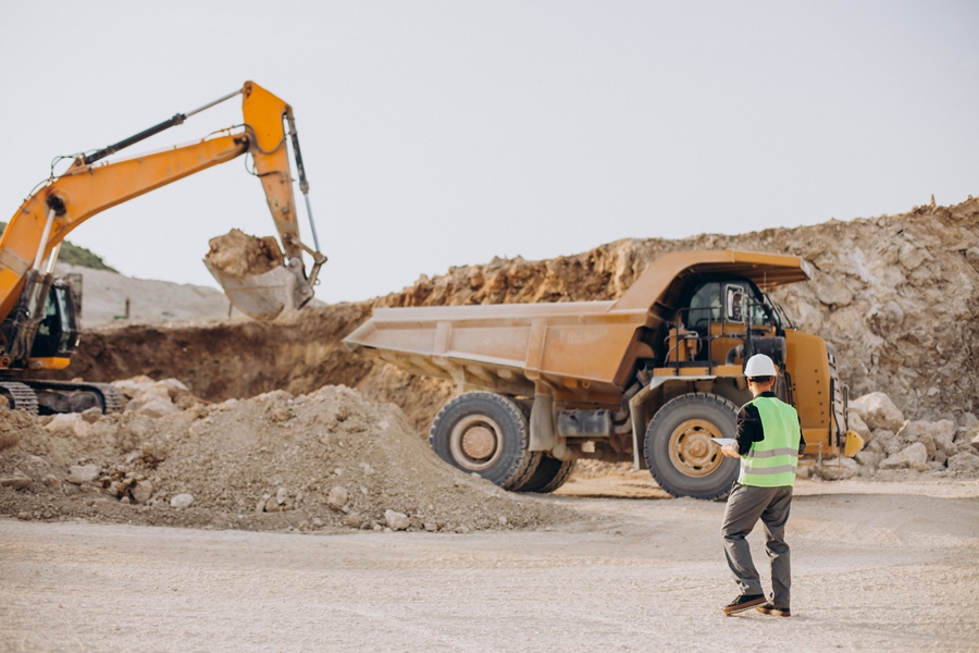 Male worker with bulldozer in sand quarry