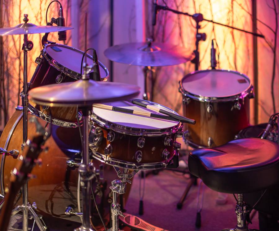 Drums, cymbals, hi hat on a beautiful background in the recording Studio. Room for musicians ' rehearsals. The concept of musical creativity and show business.