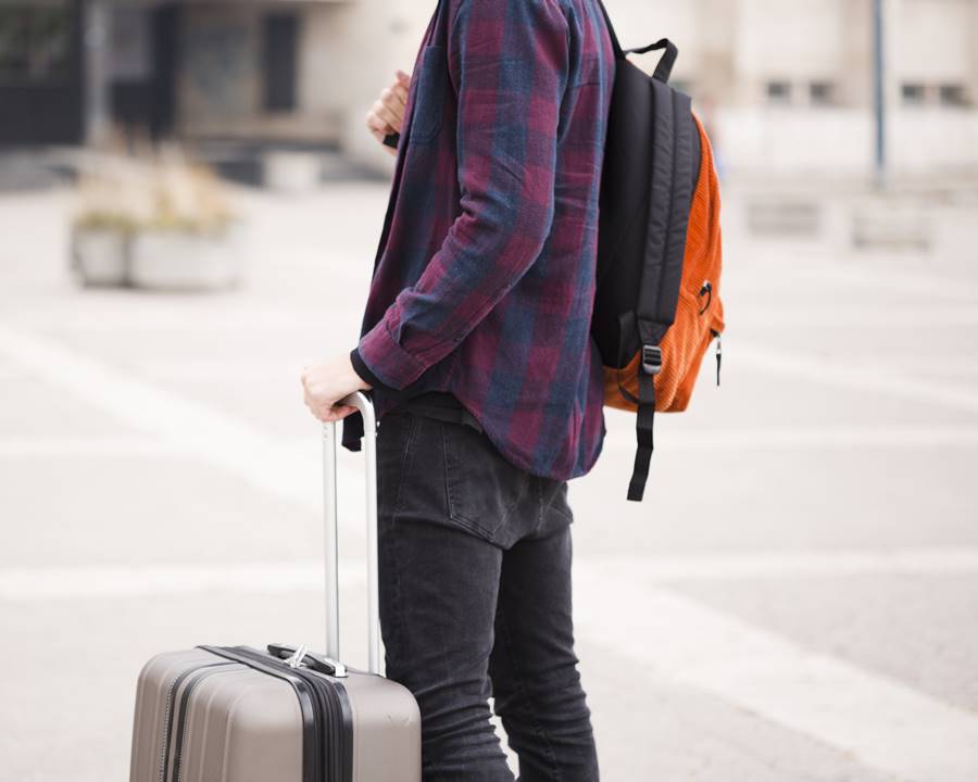 close-up-stylish-tourist-with-luggage