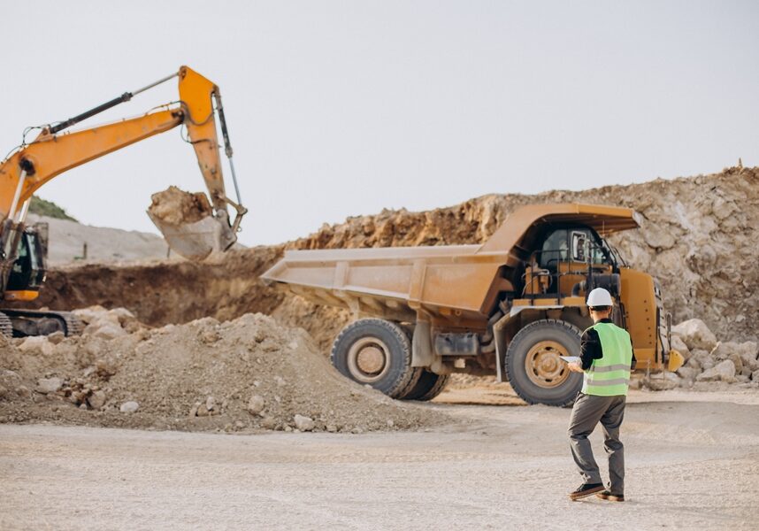 Male worker with bulldozer in sand quarry