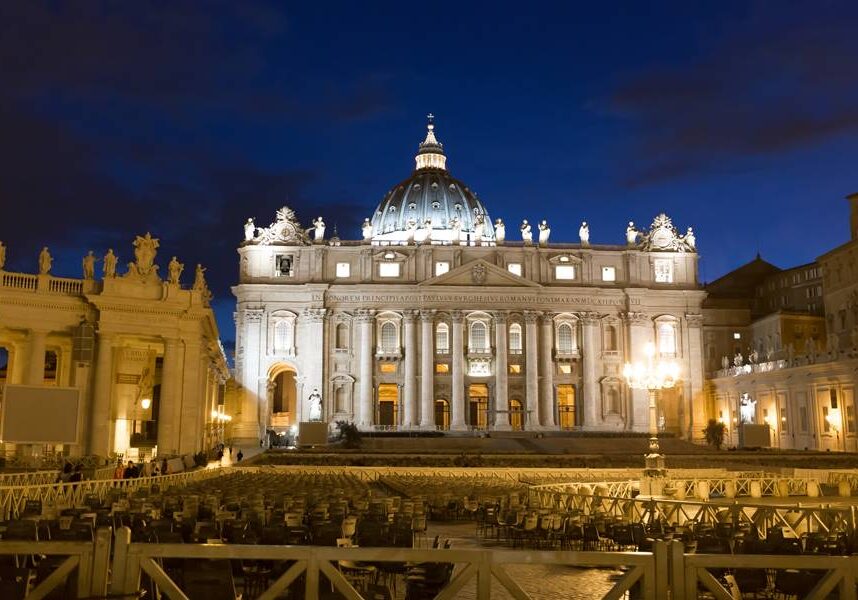 Tourism and sightseeing, night view over illuminated St. Peter's Basilica Vatican City, St. Peter's Square with benches for the event